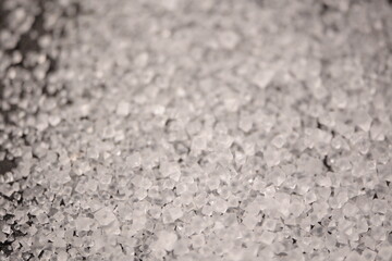 Close-up of the surface of white salt grains, macro salt