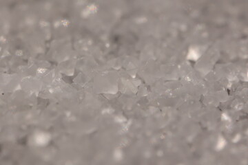 Close-up of the surface of white salt grains, macro salt