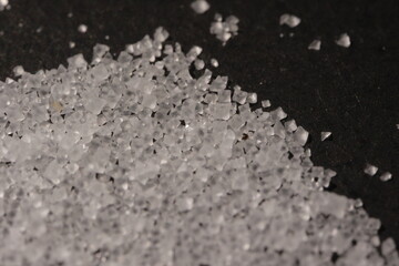 Close-up of the surface of white salt grains, macro salt