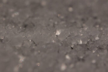 Close-up of the surface of white salt grains, macro salt