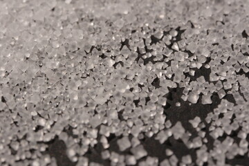 Close-up of the surface of white salt grains, macro salt
