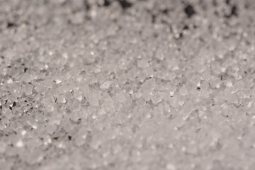 Close-up of the surface of white salt grains, macro salt