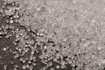 Close-up of the surface of white salt grains, macro salt