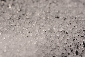 Close-up of the surface of white salt grains, macro salt