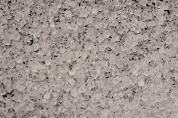 Close-up of the surface of white salt grains, macro salt