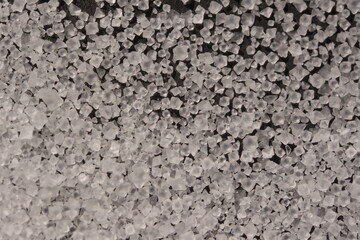 Close-up of the surface of white salt grains, macro salt