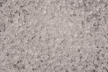 Close-up of the surface of white salt grains, macro salt