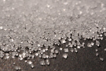 Close-up of the surface of white salt grains, macro salt