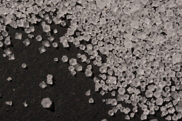 Close-up of the surface of white salt grains, macro salt