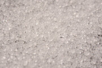Close-up of the surface of white salt grains, macro salt