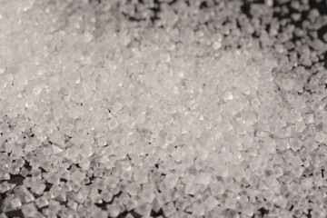Close-up of the surface of white salt grains, macro salt