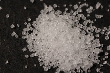 Close-up of the surface of white salt grains, macro salt