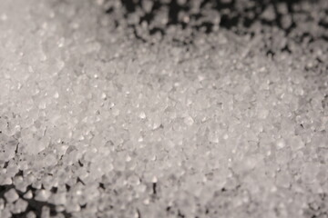 Close-up of the surface of white salt grains, macro salt