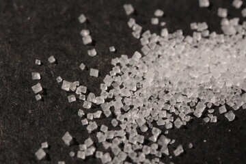 Close-up of the surface of white salt grains, macro salt