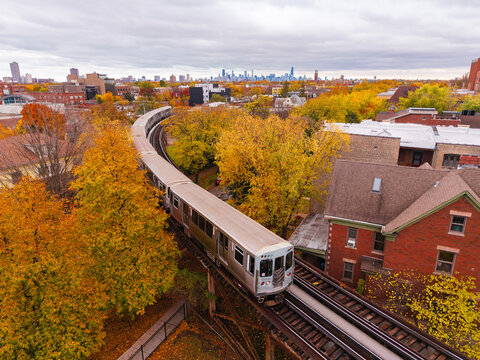 Train going through Lincoln Square chicago in the fall