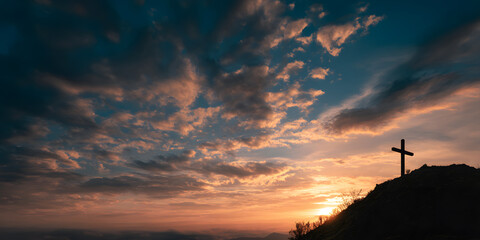 Silhouette of Christian cross atop a hill against a dramatic sunset sky with colorful clouds. Faith concept
