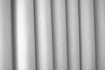 Textured gray curtains in folds on mockup overlay, highlighting the beauty of textured gray fabric for fabric shop design elements.