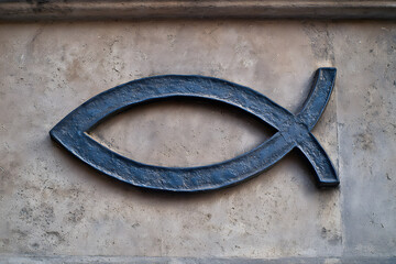 Ichthys (Christian fish symbol) carved into a stone wall. Represents faith, belief, and Christian identity.