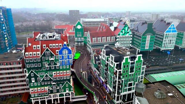 Explore vibrant, uniquely designed buildings in a charming Dutch town. This location showcases a blend of styles and colors against a moody sky, creating an intriguing urban landscape.