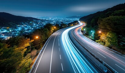 aerial view of a highway at night with long exposure lights, showing the movement and glow of cars on multiple winding, ornate roads in the mountains