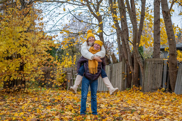 Midlife couple enjoying autumn day outdoors, surrounded by colorful fall leaves, sharing laughter and joy, creating lasting memories in a serene natural setting