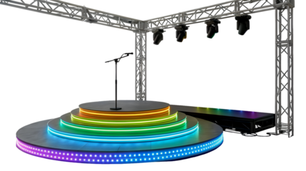 An empty tiered circular stage is illuminated by vibrant rainbow LED lights with a microphone stand at the center A metal truss with spotlights hangs overhead against a black background