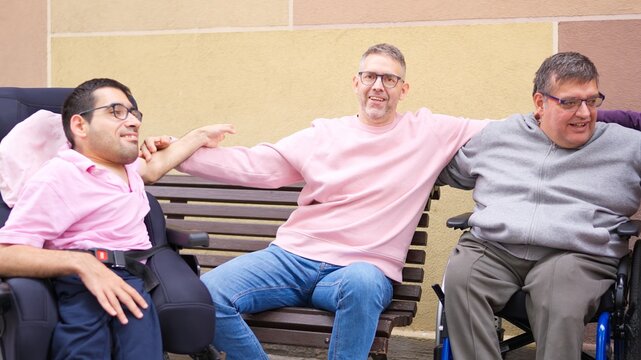 Men embracing inclusion and friendship on a bench - Powered by Adobe