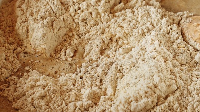 Macro close-up of flour kneading dough. Traditional healthy sourdough rye bread recipe. Gluten-free diet food, healthy baking. Bakery, handmade bread, pizza, culinary arts. Diy yeast dough baking ads