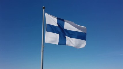 Finnish flag waving gracefully against a clear blue sky, a symbol of national pride and identity in a vibrant, dynamic display of patriotism