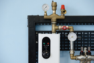 Control panel setup for machinery in an under-construction boiler room with lighting elements