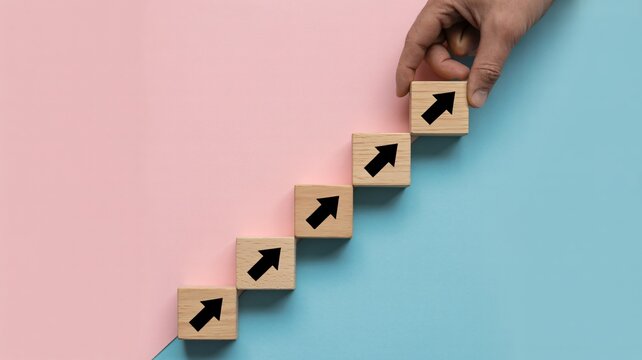 Building momentum upwards with rising arrows on stacked wooden blocks symbolizing career growth and progress