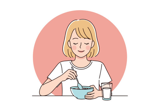 Young woman eating breakfast from a bowl with a spoon, a glass of milk beside her, representing a healthy start to the day