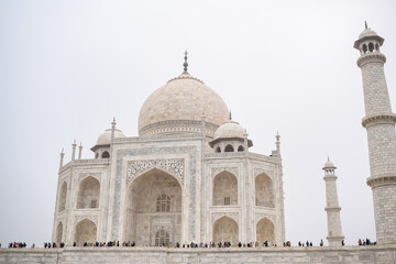 Fototapeta premium Amazing view of Taj Mahal which is among seven world wonders. Famous Indian Islamic heritage at cloudy day, Taj Mahal located at south bank of the Yamuna River