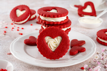 Red velvet sandwich cookies in the shape of a heart with cream cheese filling for Valentines day. Holiday dessert. Copy space.