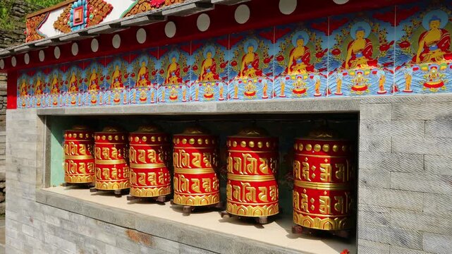 Rotating brass prayer wheels in Nepal monastery. Buddhist symbols, mantra engraving, spinning motion, cultural heritage, traditional ritual, spiritual architecture, Himalayas stock video