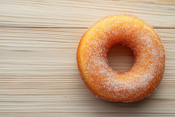 Top View of Sugared Cruller Donut Ring on Light Wooden Surface