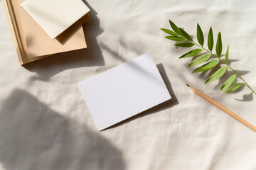 Blank card mockup with leaf shadow and pencil
