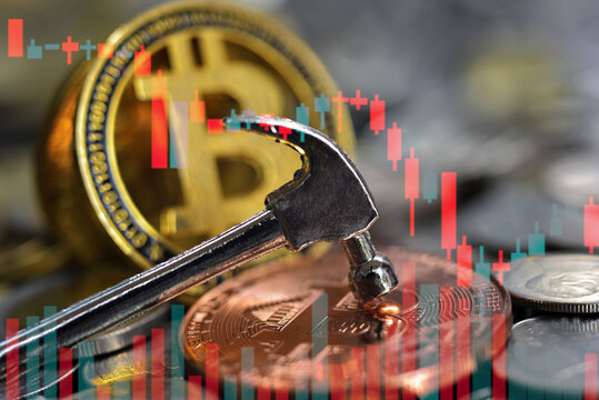 cryptocurrency is smashed by hammer with candle stick chart indicator for slash  price concept. Global investment are digital asset and risk assets. Investor must accept the fluctuation.  Investor mus