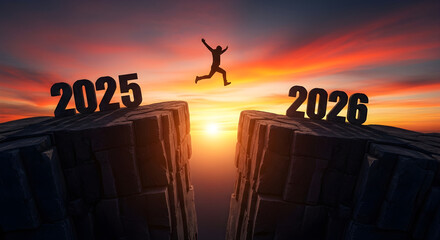Silhouette of a man jumping across a dangerous cliff or chasm from the rock labeled 2025 to the rock labeled 2026 at a dramatic sunset