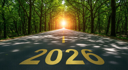 Empty forest road or highway stretching toward a bright sun flare, with the golden number 2026 painted on the asphalt, symbolizing a path to the future