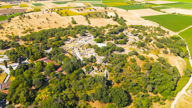 Tevfikiye, Turkey. Aerial view of the archaeological layers of the ancient city of Troy, showing the ruins of city walls, fortifications and the ancient theatre on a clear summer day. Aerial view