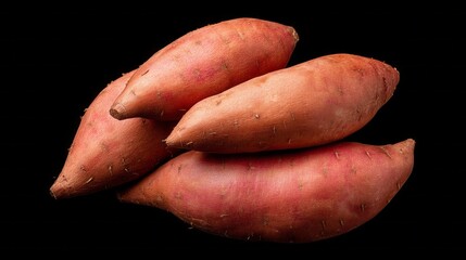 Bright orange organic sweet potatoes lie in a neat pile against a dark background, showcasing their earthy texture and rich color. Perfect for nutritious meals and recipes