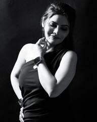 Monochrome studio portrait of an elegant woman in a one-shoulder dress with minimal accessories, expressing calm confidence. Perfect for fine-art, fashion, and emotional storytelling.