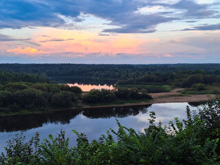 A beautiful evening landscape with a wide river, lake, and forest. Vetluga River, Nizhny Novgorod Region, Russia. Nature of the European part of Russia.