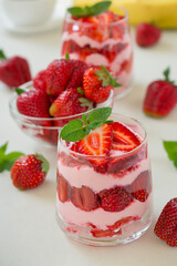 A refreshing strawberry smoothie, topped with fresh slices and a hint of mint, highlights the sweetness of summer.