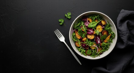 Fresh and healthy salad with roasted vegetables and greens on a dark background. Delicious salad with roasted vegetables, photo above