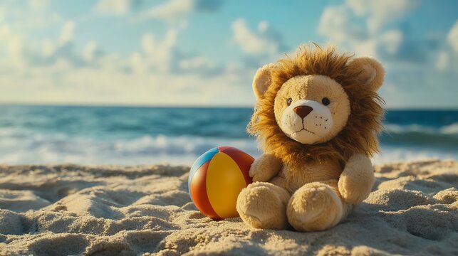 Stuffed lion with a beach ball by the sea