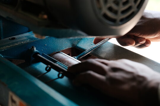 Hands Adjusting Thickness Planer with Wrench