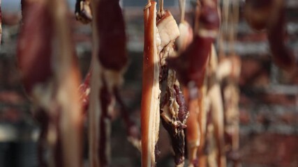 Cured Meat Strips Hanging to Dry - Traditional Food Production