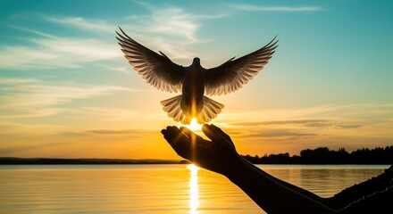 A bird takes flight from an open hand against a golden sunset over calm water. The scene represents freedom, hope, and new beginnings. Perfect for spiritual themes and motivation.